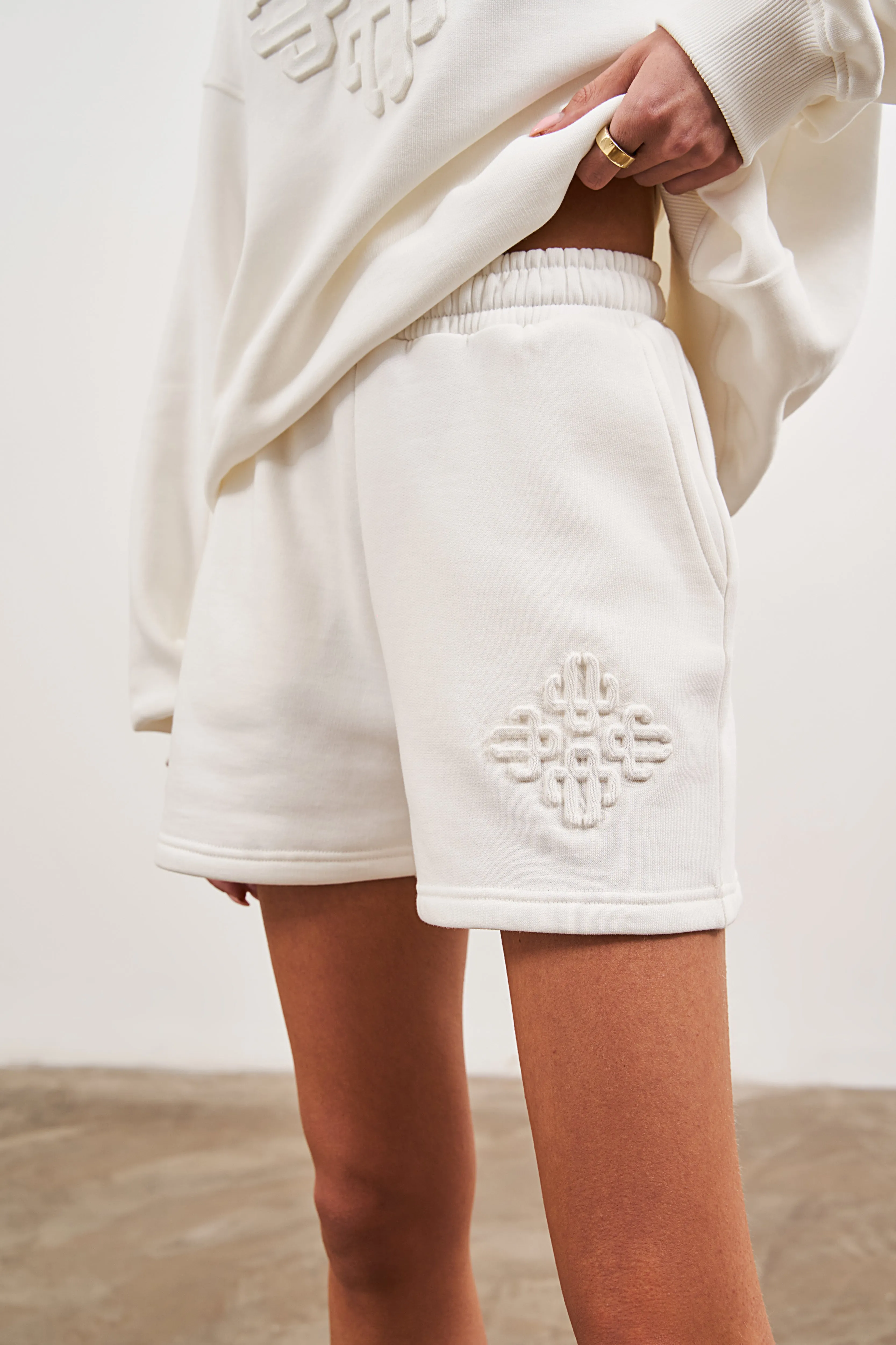 EMBLEM EMBOSSED SHORTS - OFF WHITE